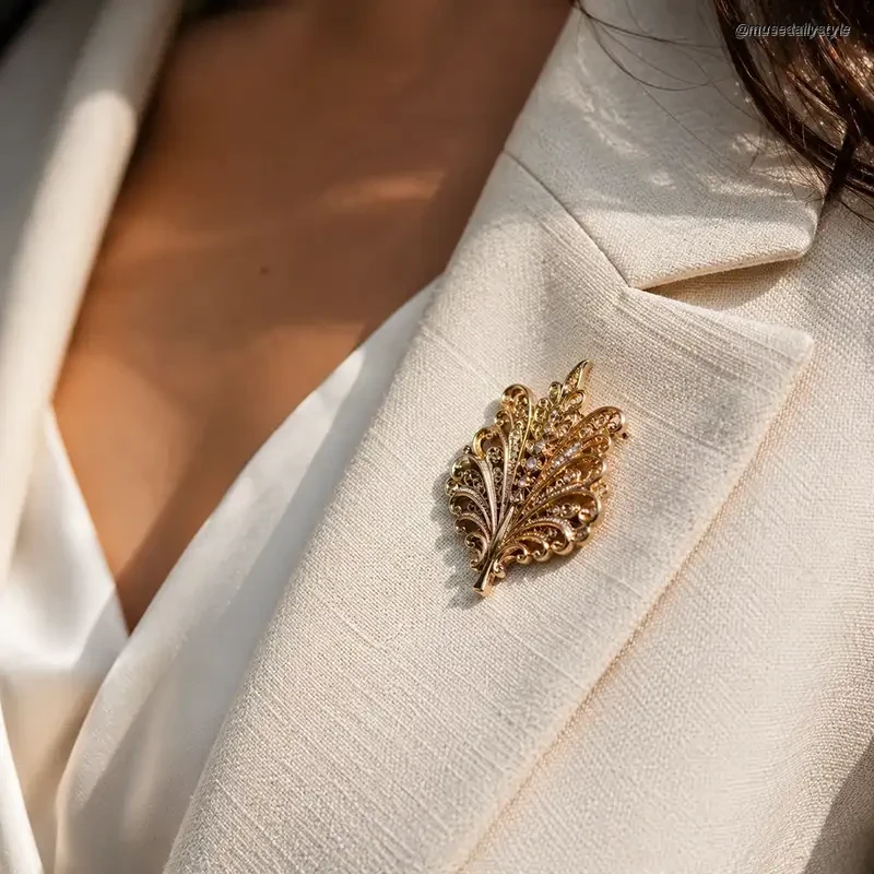 tailored blazer lapel with a vintage gold brooch pinned to it